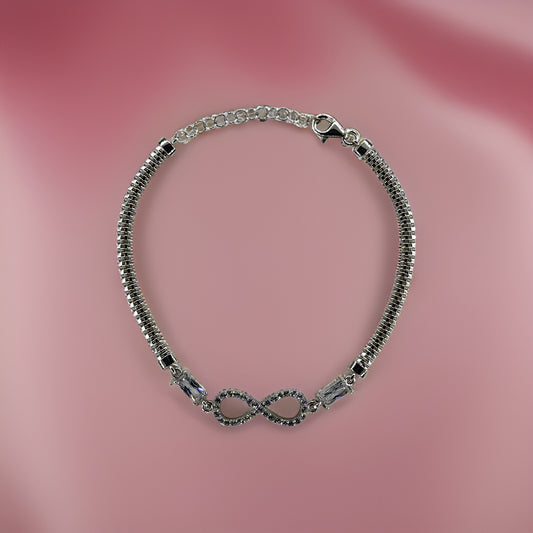  Silver infinity charm bracelet on pink.